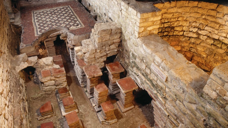 Roman baths at Chedworth Roman Villa West Wing showing mosaic floor and hypocaust system